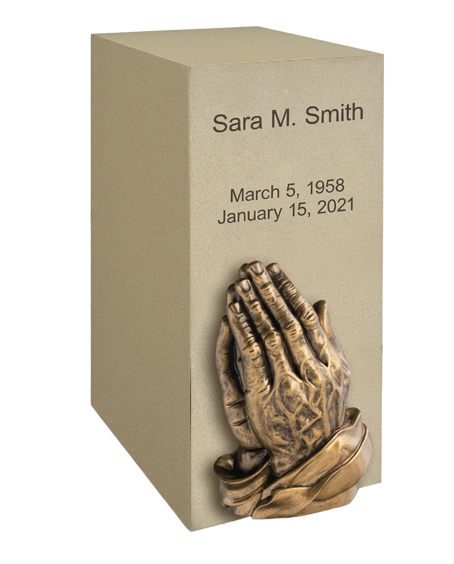 Cast stone memorial block engraved with a name and dates, with a bronze relief on the front